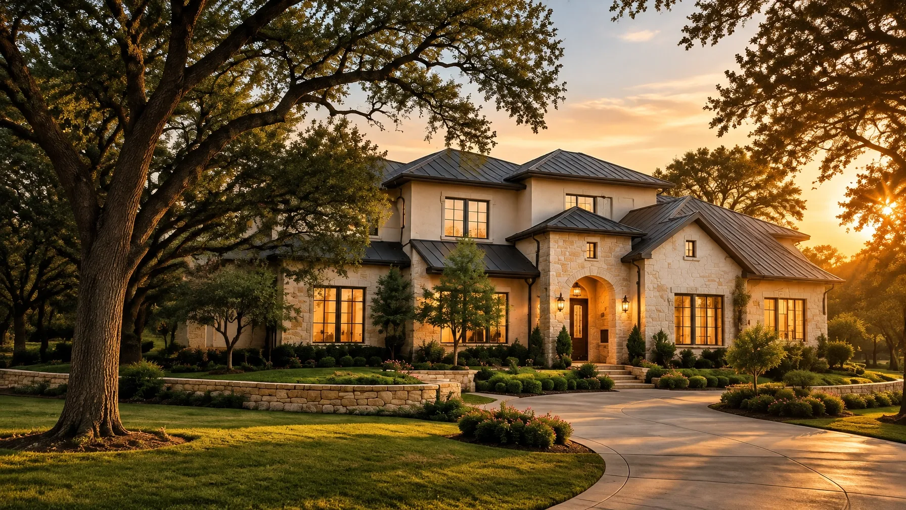 Elegant North Texas stone-and-stucco estate at golden hour beneath mature oak trees